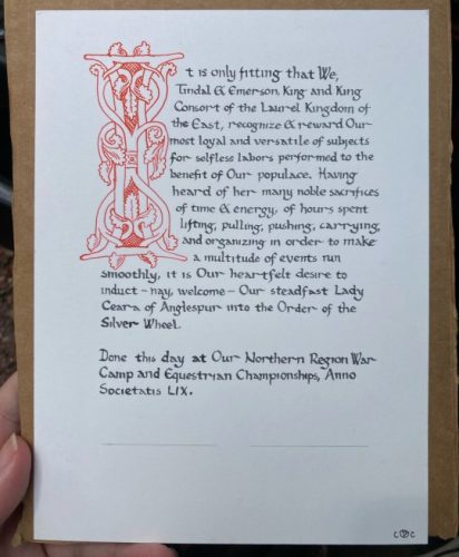 Inked Ottonian capital and Carolingian hand, a Silver Wheel kingdom level arts award.