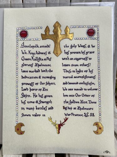 A Golden Alce merit-level AEthelmearc award for martial activity, based on the recipient's AoA (done by Baroness Sadira), his helm, and the hand from the Uppsala Eddas.